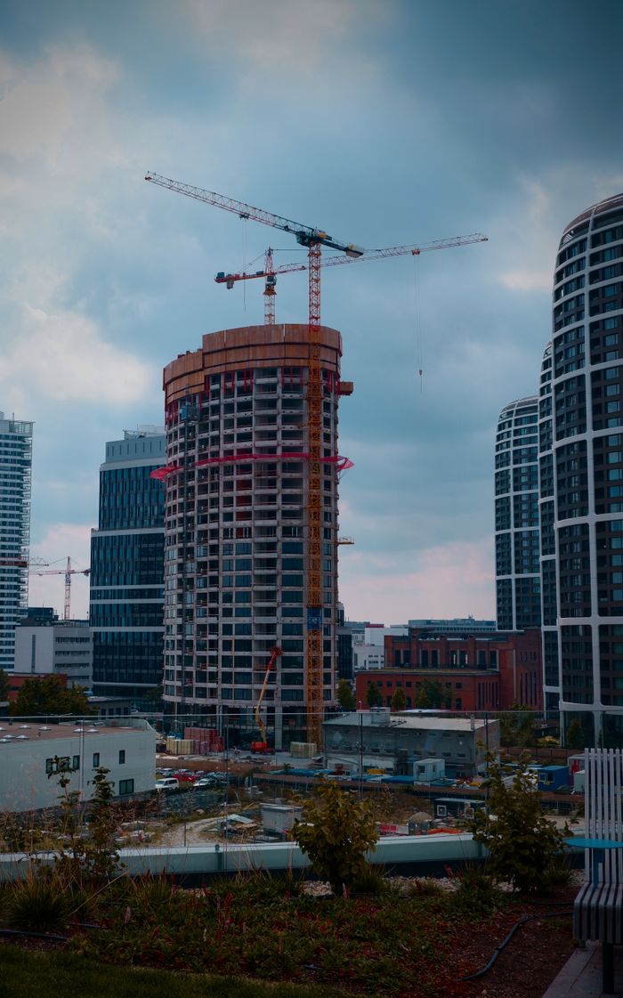 Construction cranes over an urban site, William Gevorg Urban on Pexels