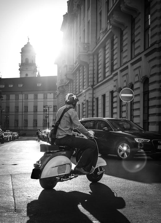 Man Riding Motor Scooter