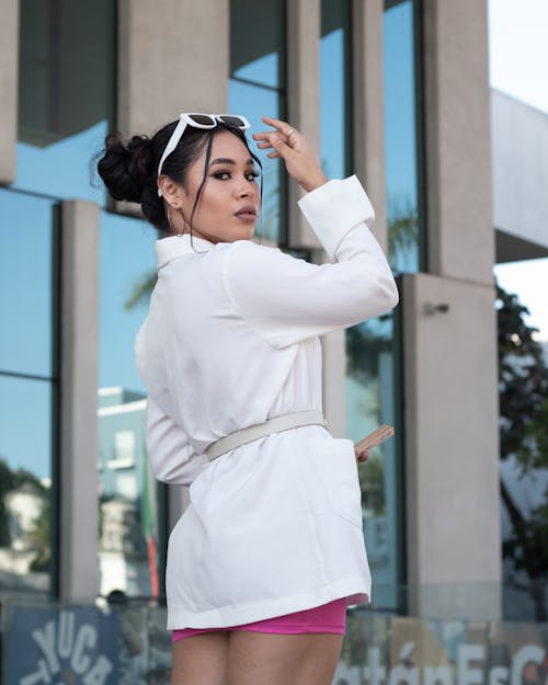 Beautiful Woman in White Jacket with Sunglasses on Head