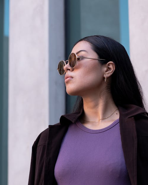 Beautiful Young Woman with Sunglasses Looking Away