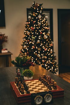 Cozy indoor scene featuring a decorated Christmas tree and intricate chess set on a table, perfect for holiday ambiance.