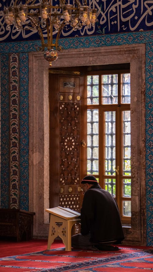 Photo of a Man Reading Koran 