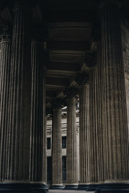 Tall neoclassical columns in Saint Petersburg, Russia, showcasing historic architecture.