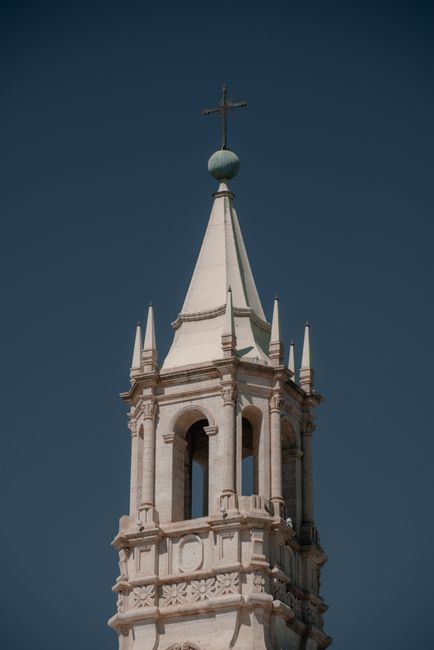 Majestic view of a historic bell tower under a clear blue sky in Arequipa, Peru.