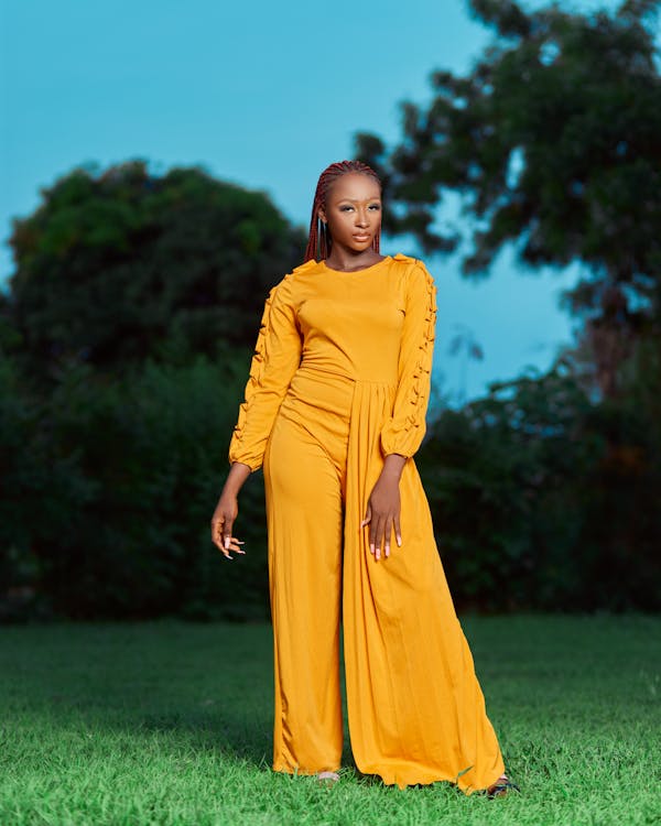 Young Woman in a Yellow Dress Posing Outdoors 