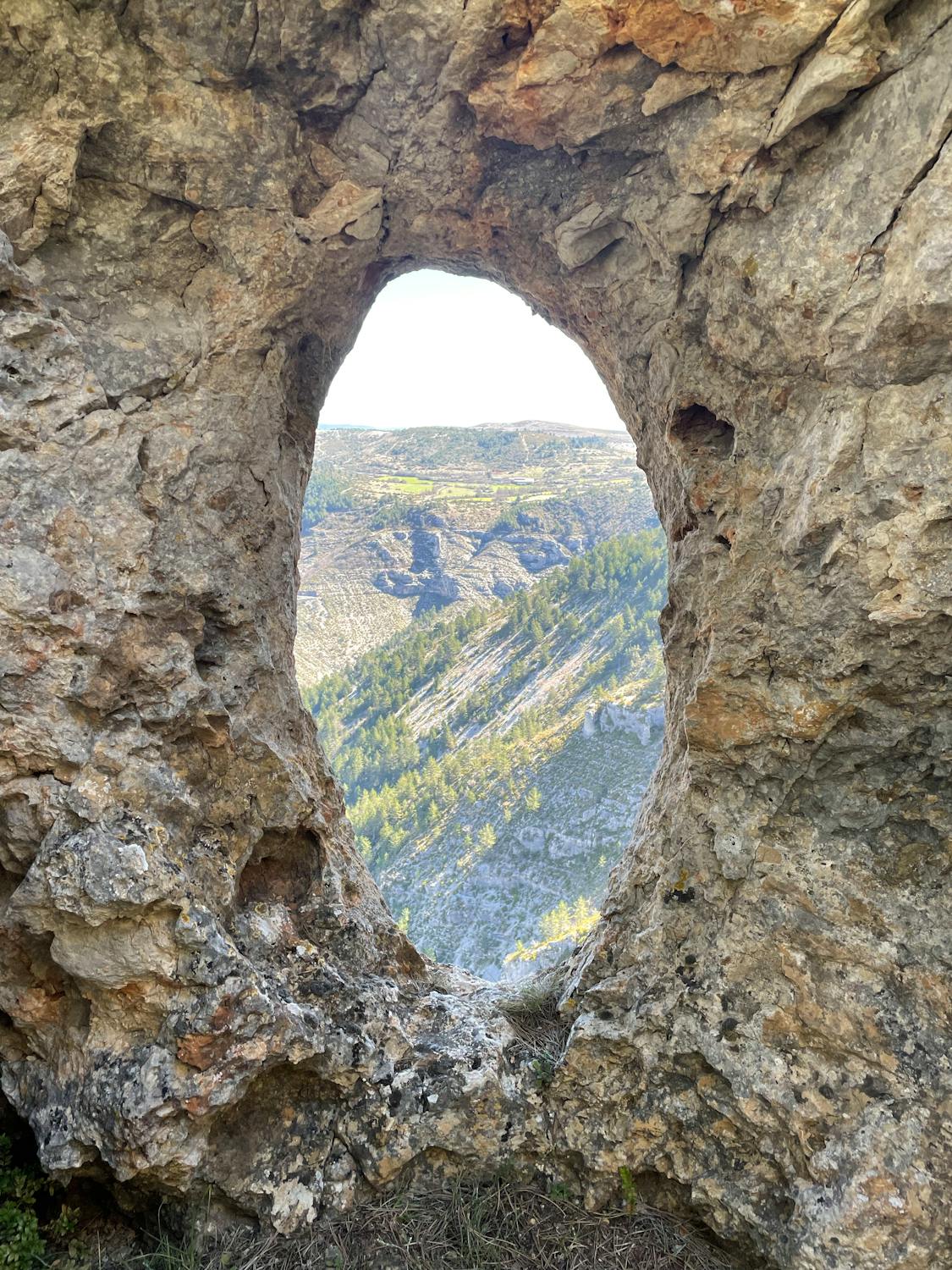 View of Mountains through a Hole in the Rock · Free Stock Photo
