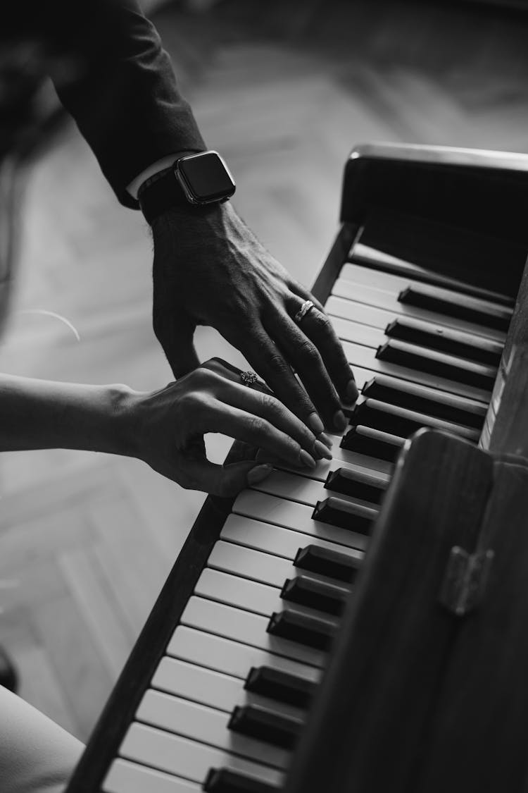 Woman And Man Hands Playing Piano