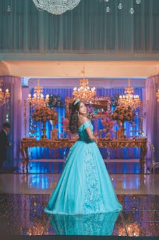 Beautiful quinceañera celebration featuring a teenage girl in a vibrant blue dress, surrounded by luxurious decorations.