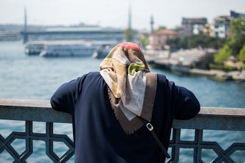 Woman Looking at the Water of the Strait from a Bridge