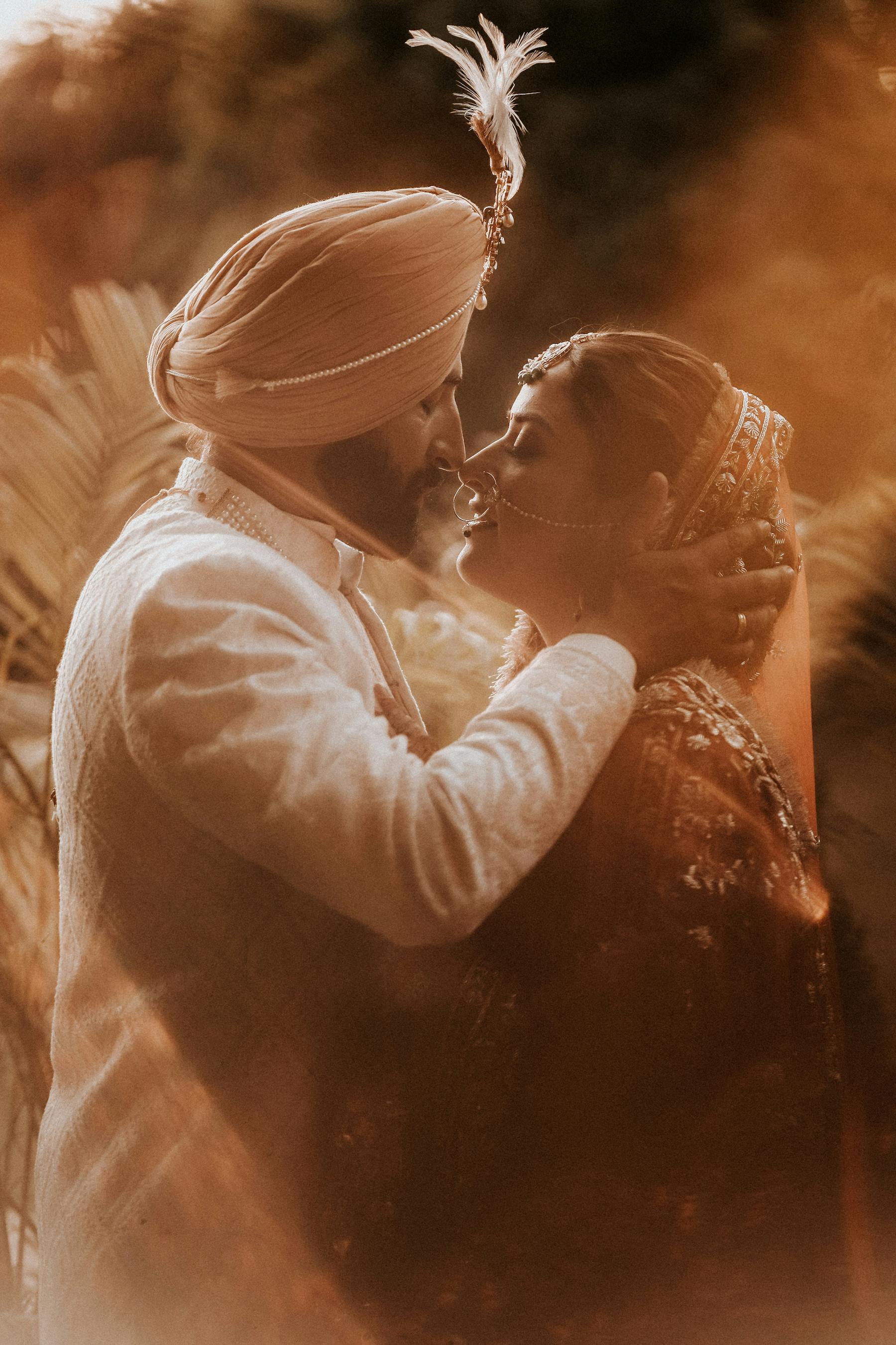 newlyweds in traditional clothing kissing