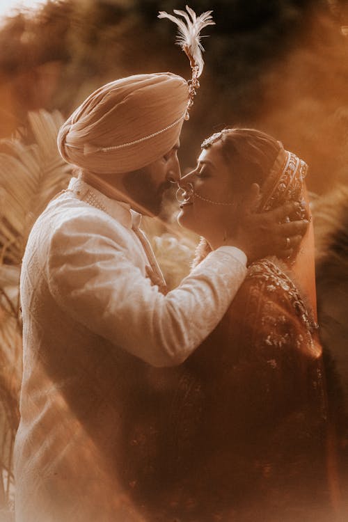 Newlyweds in Traditional Clothing Kissing