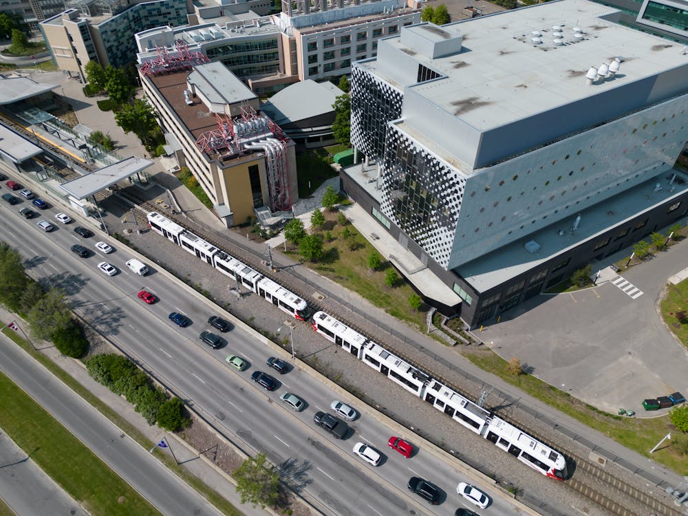 Trains and Cars on Street in Town