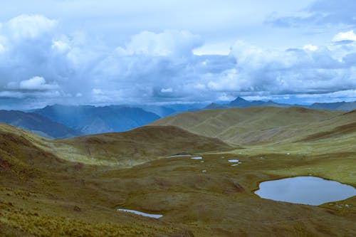 Landscape of Mountains under a Cloudy Sky 