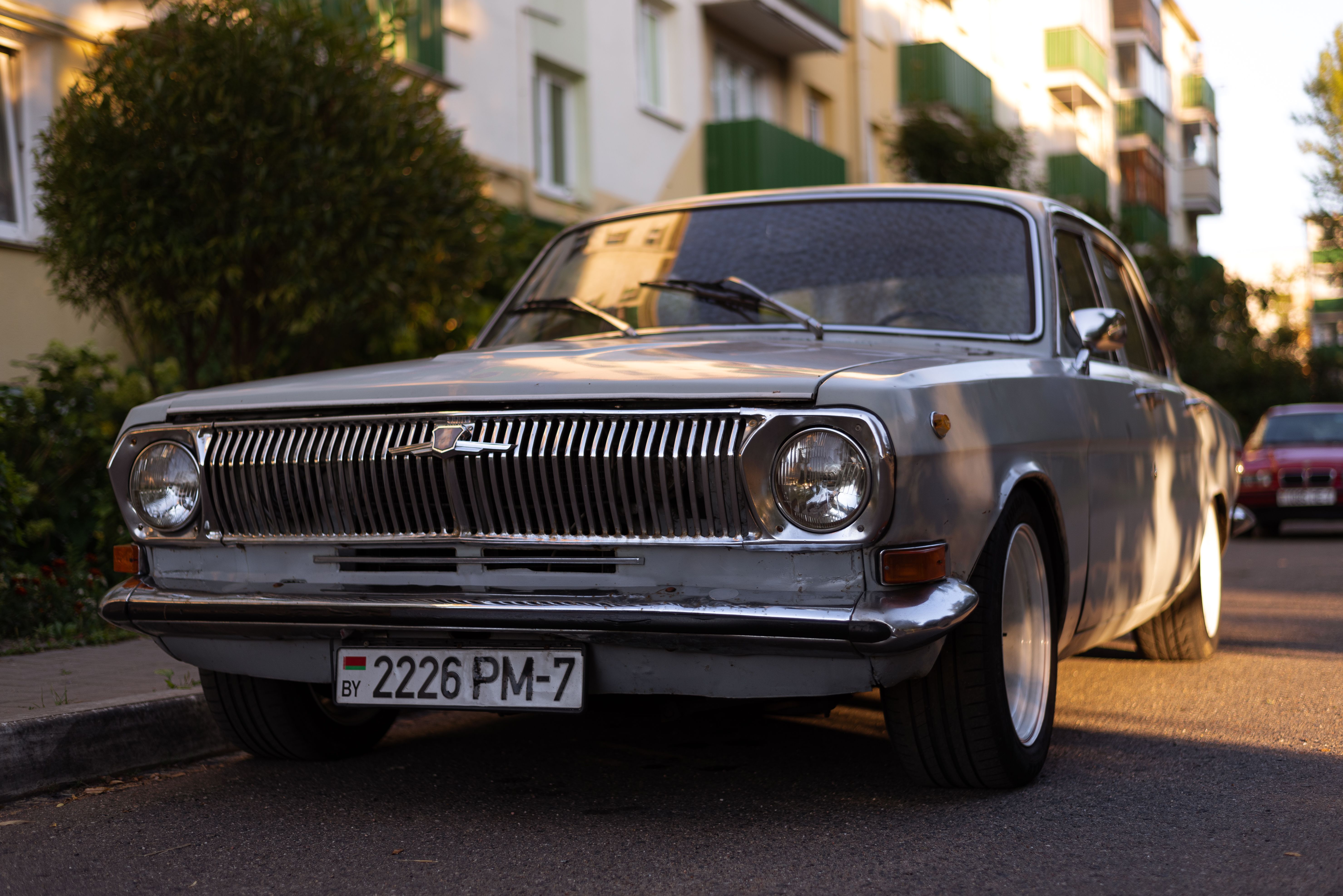 Classic Gaz-24 car parked on a sunny city street during the day.