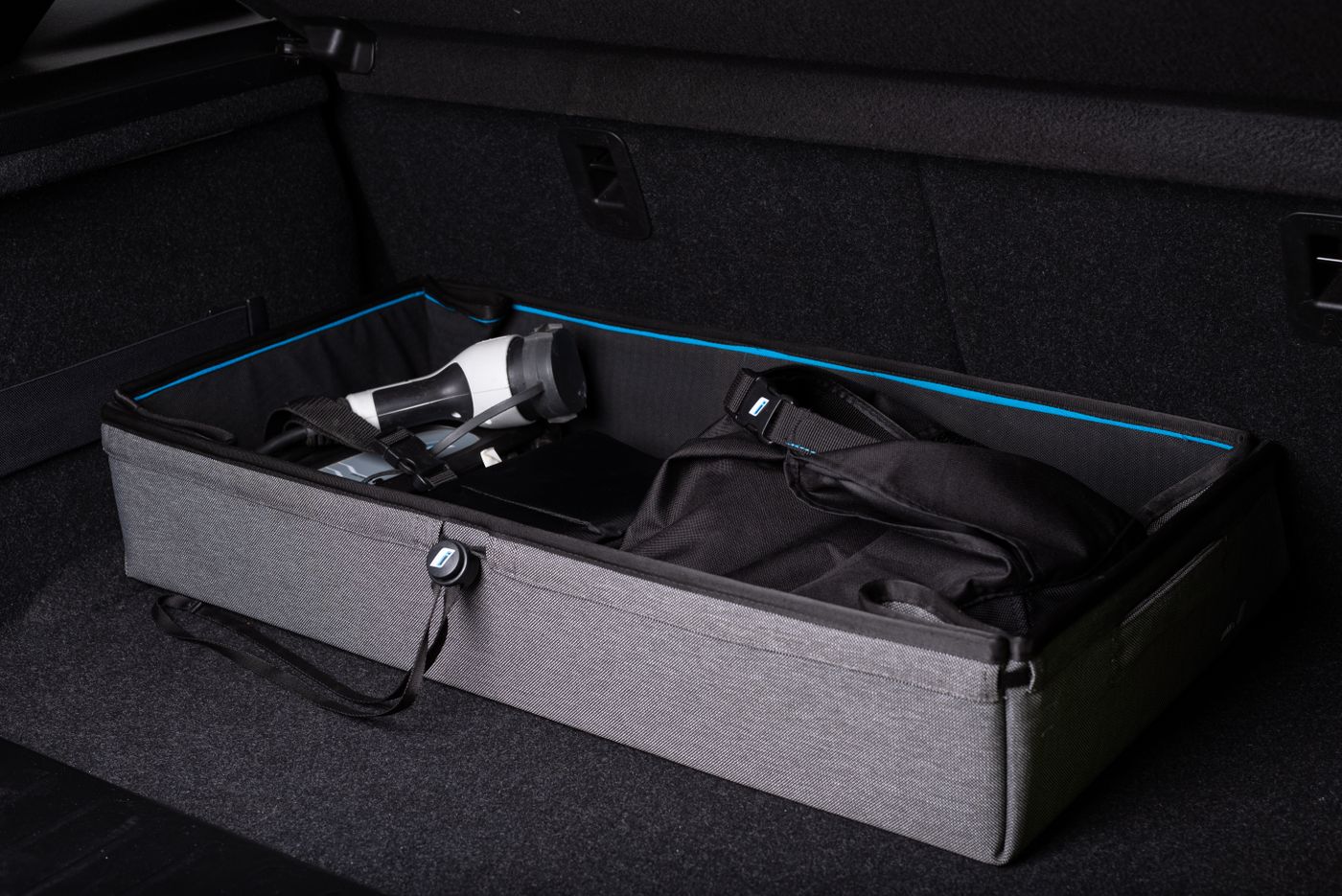 Organized car trunk with storage container and travel items