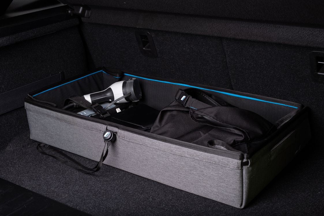 Organized vehicle trunk with structured storage and travel gear