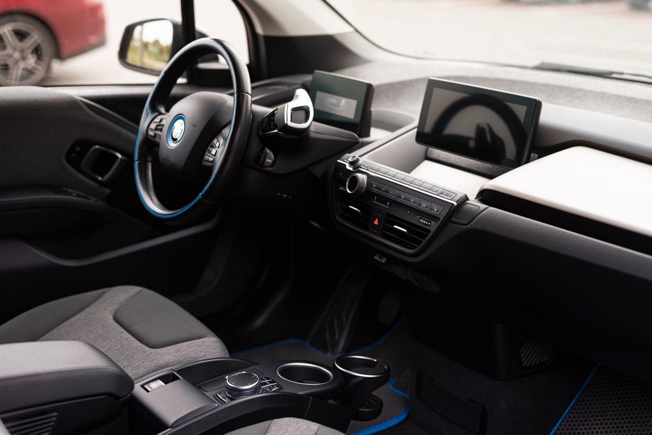Close-up of a modern car interior showing the dashboard, steering wheel, and controls. - High Quality Performance Evaluation