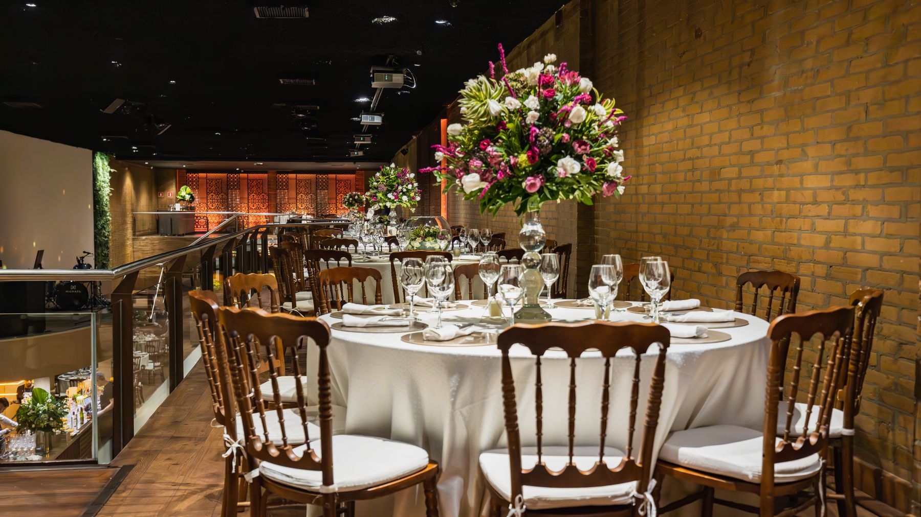 Beautifully arranged dining table with flowers for an elegant indoor wedding reception.