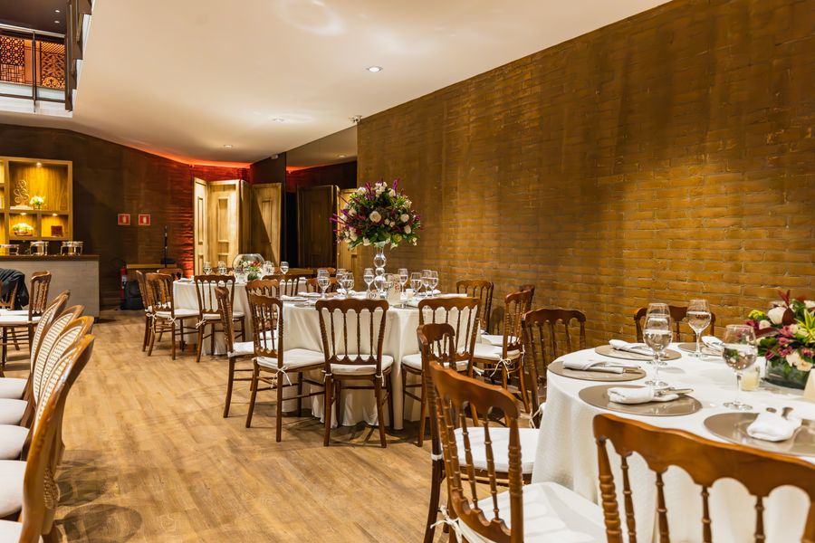Reception hall set with white linens and garden florals