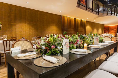 Decorated Tables with Flowers and Tableware in Restaurant 