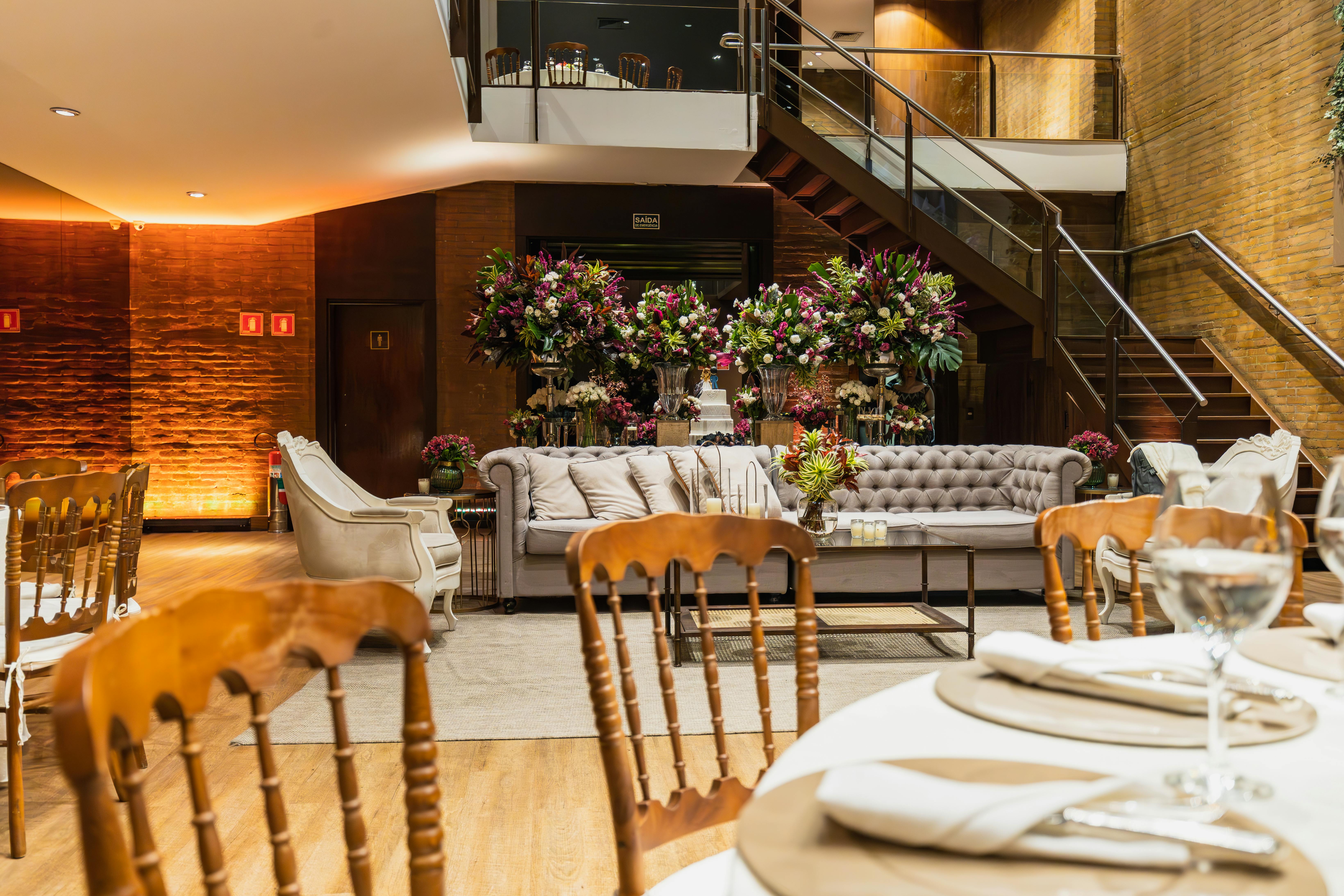 Luxurious indoor wedding reception with elegant seating and floral decorations.