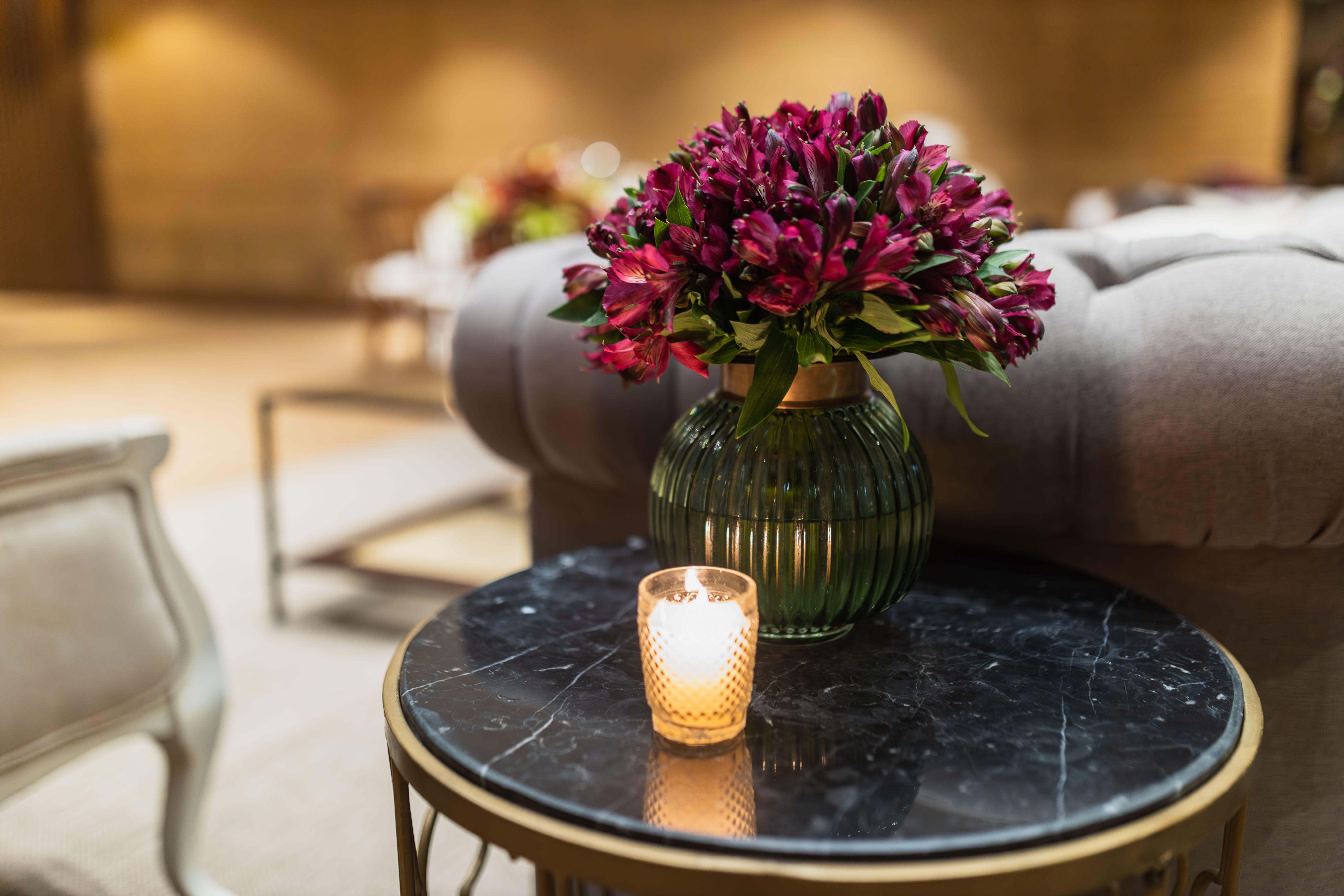 Side Table with a Candle and Flower Arrangement · Free Stock Photo