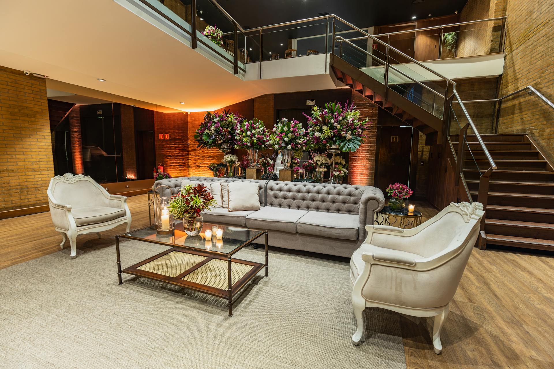 Luxurious hotel lobby with elegant furniture, flowers, and a cozy ambiance.