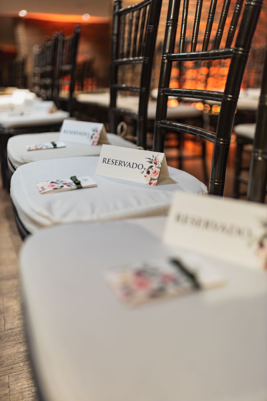 Row of reserved wedding seats with floral detail
