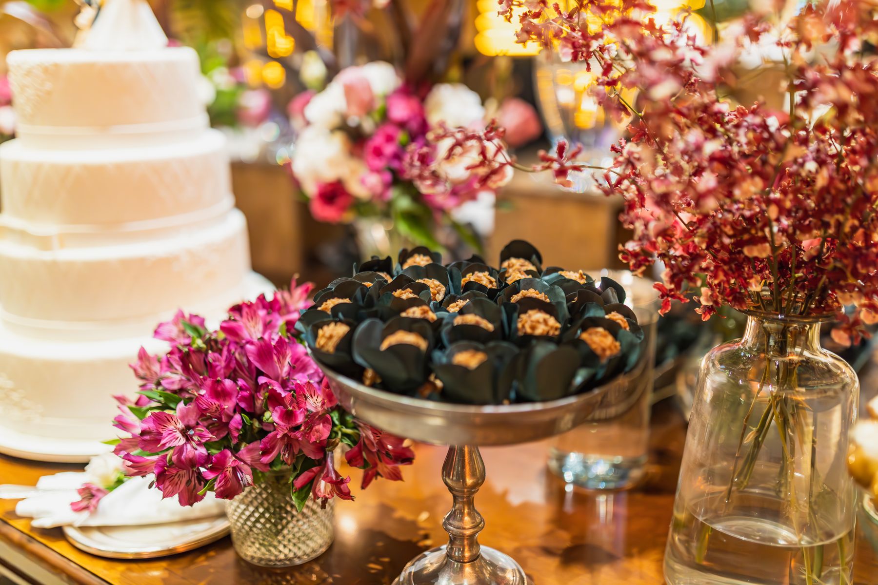 Wedding dessert table with cake, flowers and sweets