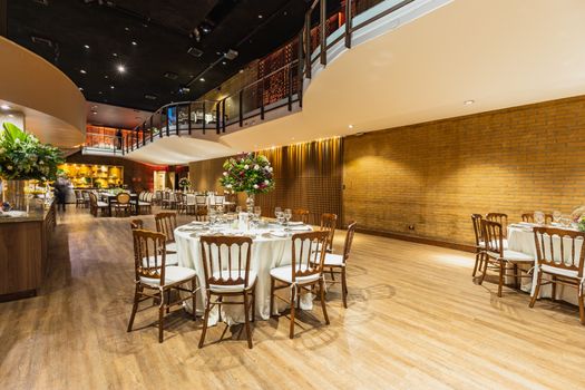 Luxurious indoor reception area set for a wedding with elegant decorations.