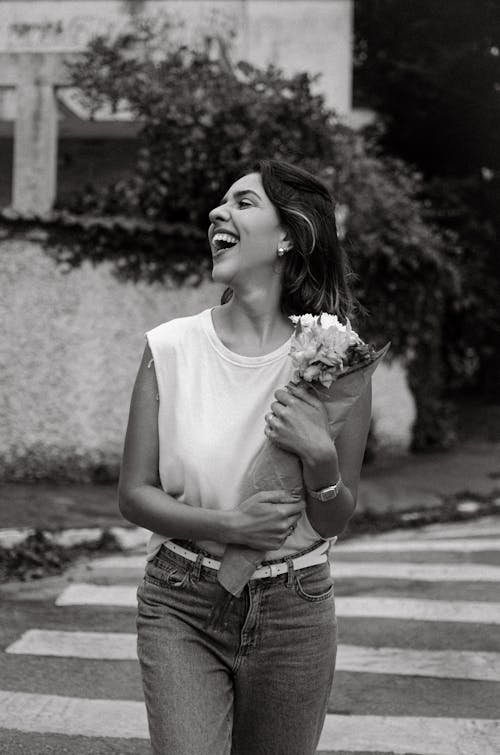 Laughing Young Woman with a Bouqet, Crossing the Street