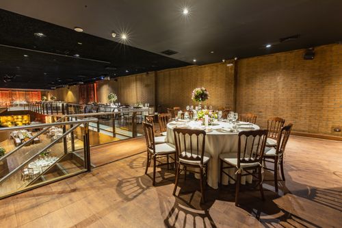 Free Spacious banquet hall with round tables set for a sophisticated event, featuring elegant decor. Stock Photo