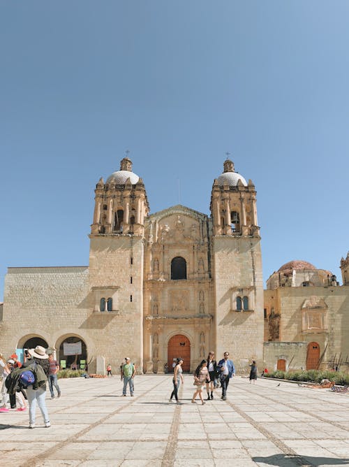 People Walking near Stone Cathedral 