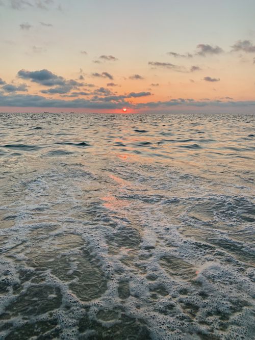Free Beautiful ocean view at sunset in Mazunte, Oaxaca, Mexico with gentle waves and colorful sky. Stock Photo