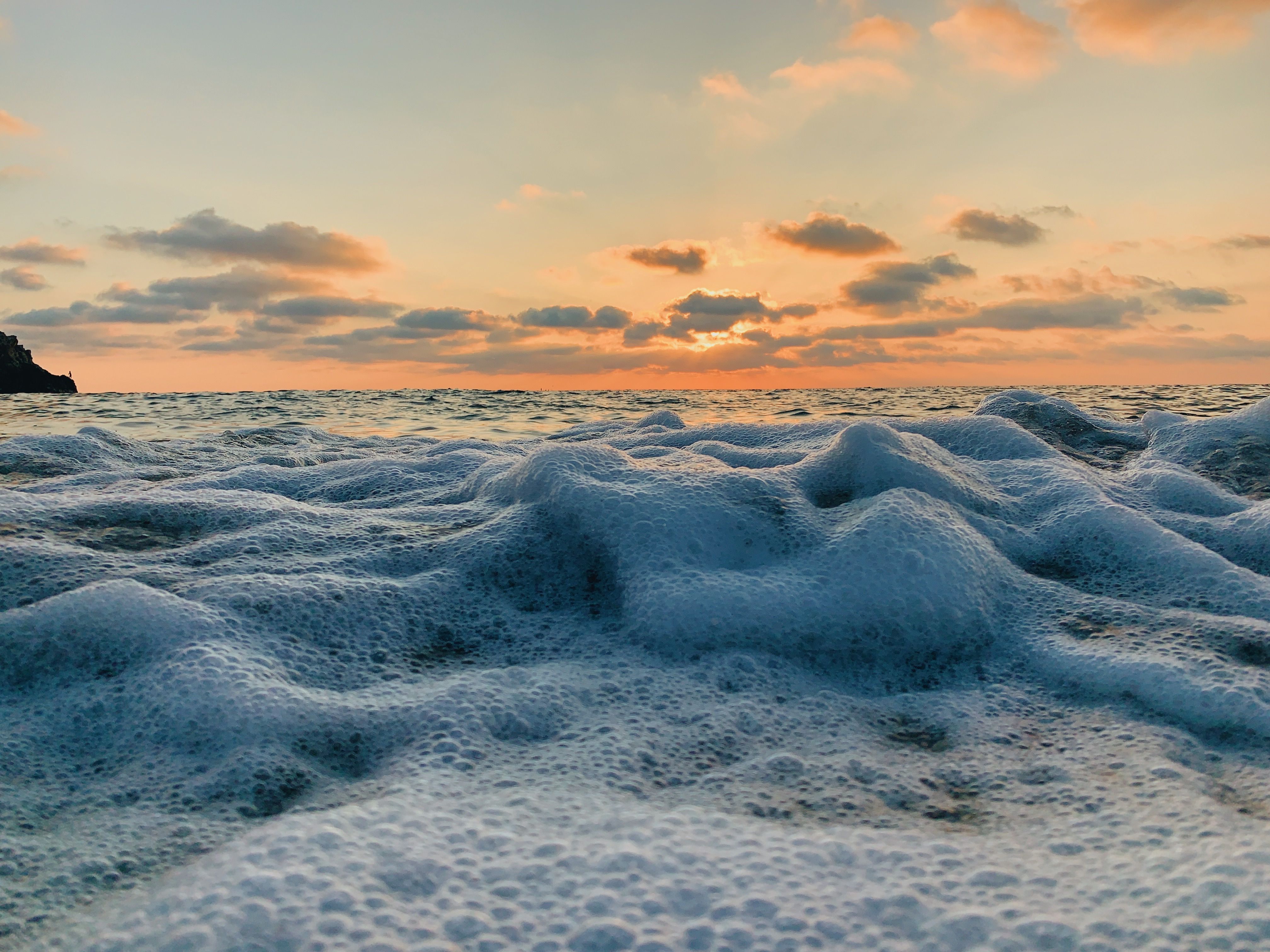 Sunset over Foamy Sea Waves · Free Stock Photo