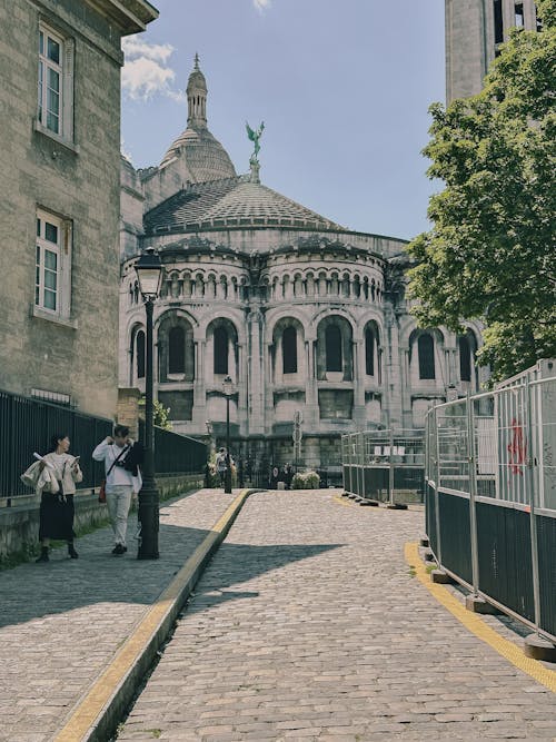 Church behind Sunlit, Cobblestone Street