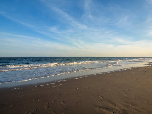 View of an Empty Beach and Sea under Blue Sky 