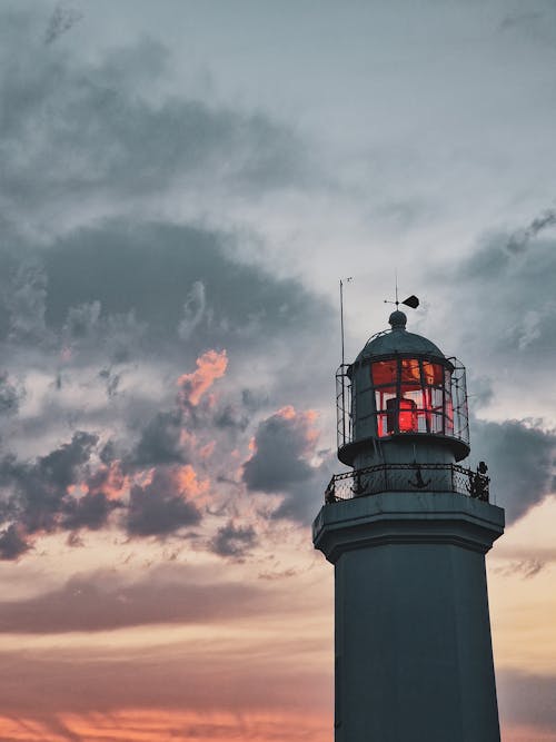 Lighthouse against Cloudy Sunset Sky