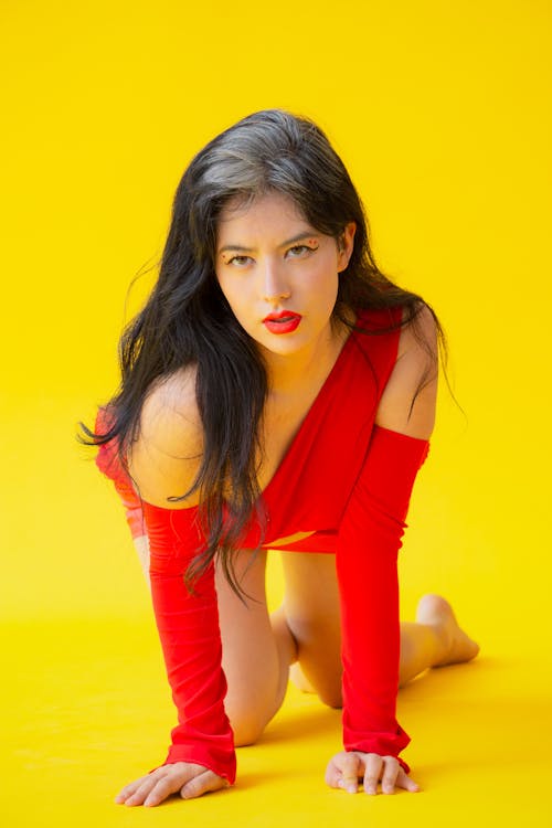 Young Woman in a Red Outfit Posing in Studio 