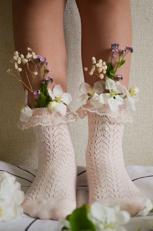 Laced Socks on the Feet with Flowers Inside