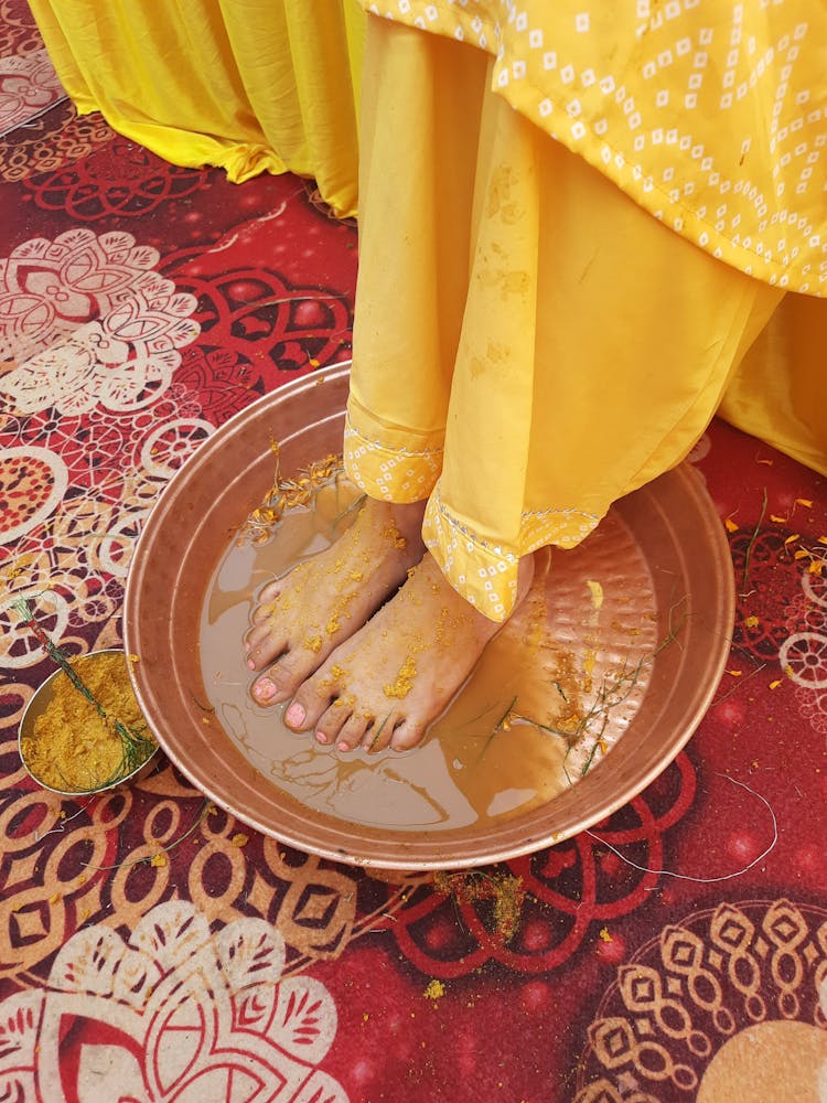 Womans Feet In A Golden Bowl