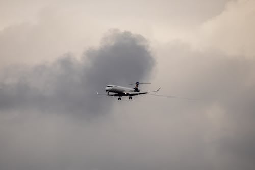 Plane Flying in Cloudy Sky