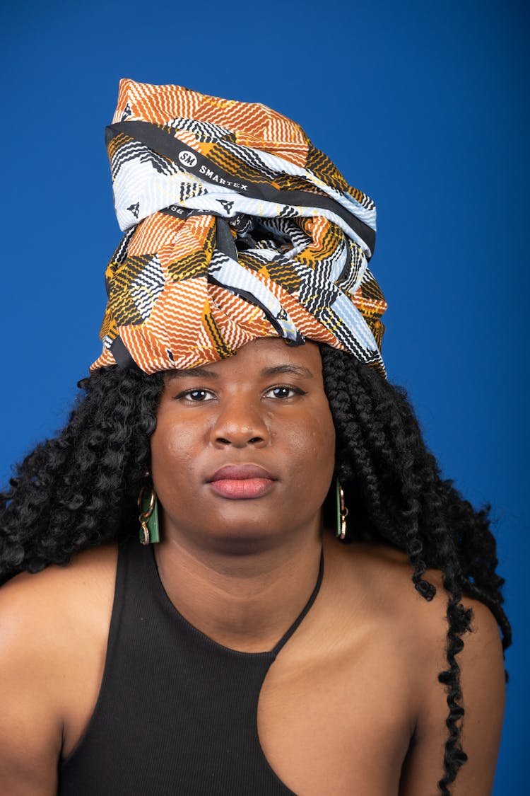 Portrait Of Young Woman In Headwear Posing In Studio