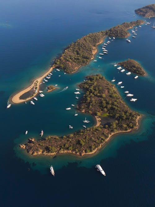 Aerial Photo of Few Islands Surrounded by Boats
