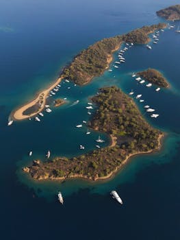 Stunning aerial shot of Yassica Ada Island with anchored boats and turquoise waters in Turkey.