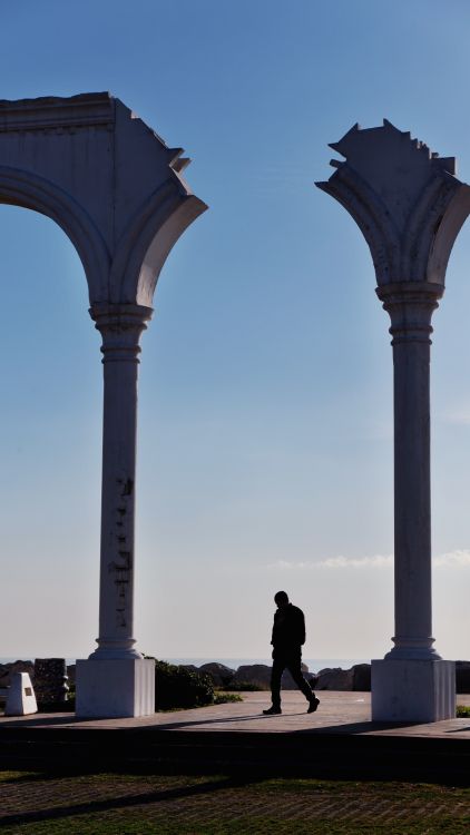 Walked Column Man Walking between Damaged Columns · Free Stock Photo