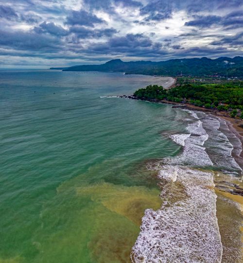 Free A serene aerial view of Cisolok's vibrant coastline in West Java, Indonesia. Stock Photo