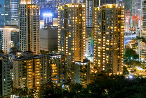 Free Stunning cityscape at night featuring illuminated skyscrapers and urban lights. Stock Photo