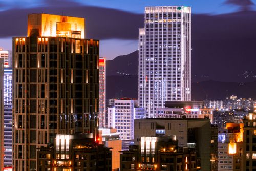 Free Vibrant cityscape of Taipei's illuminated skyscrapers against a night sky. Stock Photo