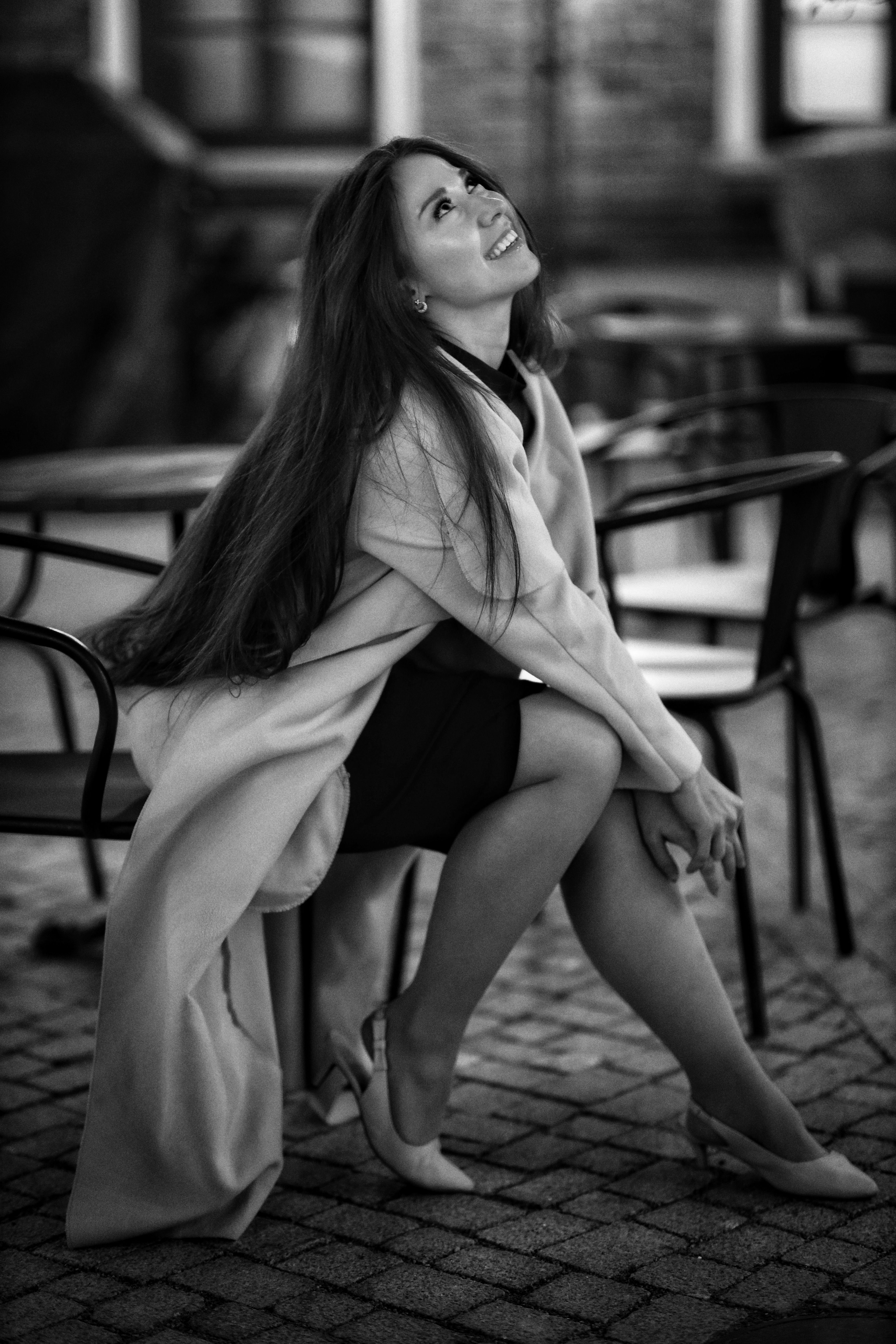 Smiling Woman Sitting in Sidewalk Cafe · Free Stock Photo